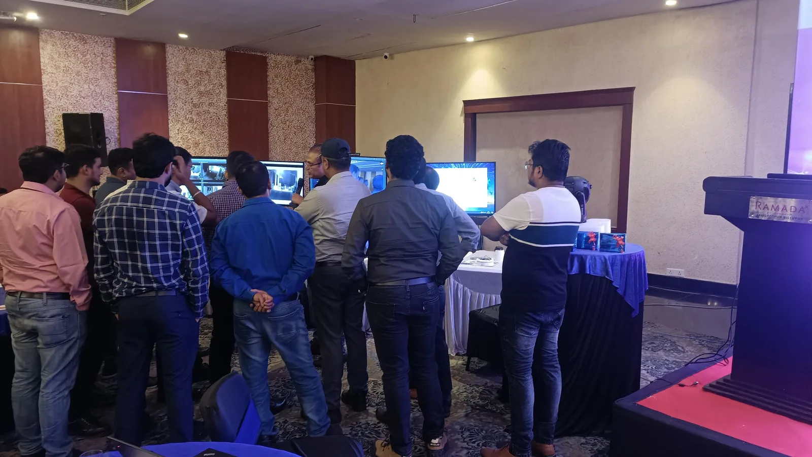 Attendees gathered around a technology demonstration